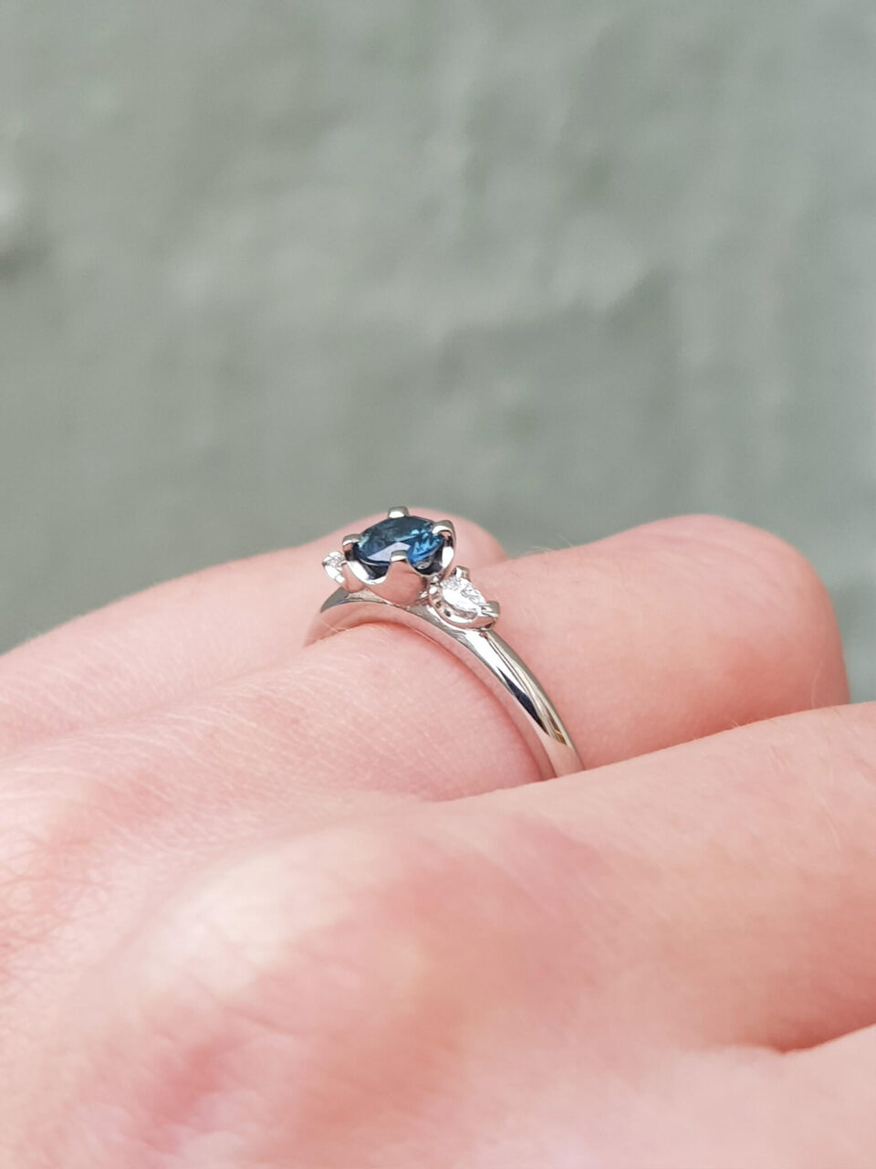 Australian teal sapphire and diamond trilogy engagement ring