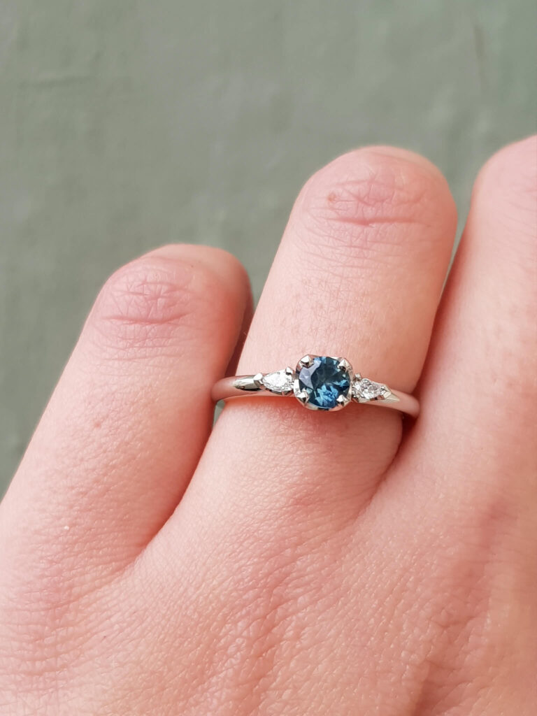 Australian teal sapphire and diamond trilogy engagement ring