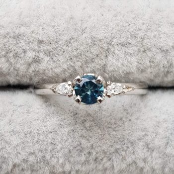 Australian teal sapphire and diamond trilogy engagement ring